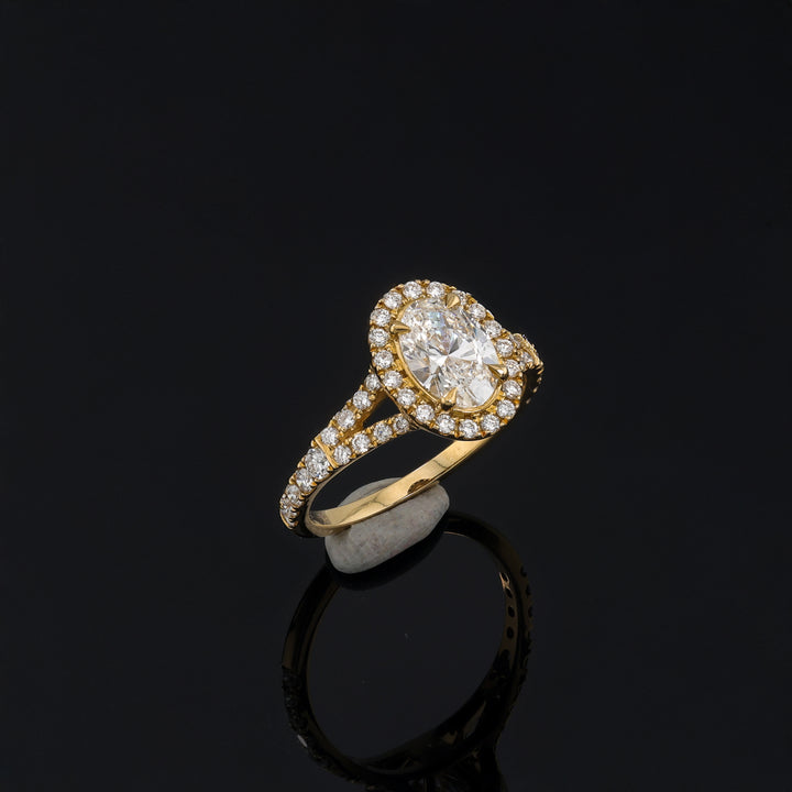 Teardrop Oval Ring in 18K Gold with sparkling diamonds, elegant design by Fox Jewelry on black background.