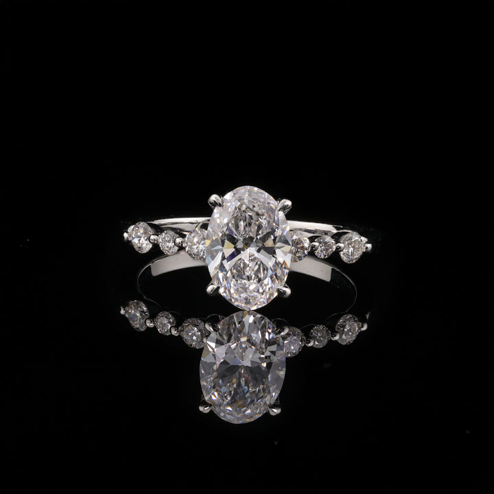 Oval Ring with sparkling oval centerpiece and side diamonds, showcasing timeless elegance from Cartier Jewelry.